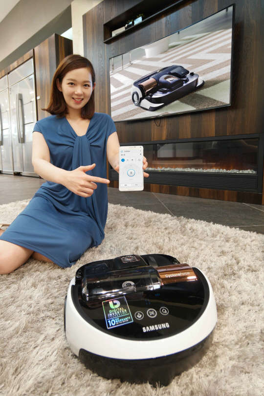 삼성전자 모델이 2일 논현동 삼성 디지털프라자 강남본점에서 스마트폰 애플리케이션으로 간편하게 조작할 수 있는 진공흡입 로봇청소기 '파워봇' 신모델을 소개하고 있다. <삼성전자 제공>